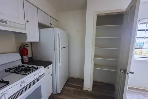 a kitchen with a stove and a refrigerator