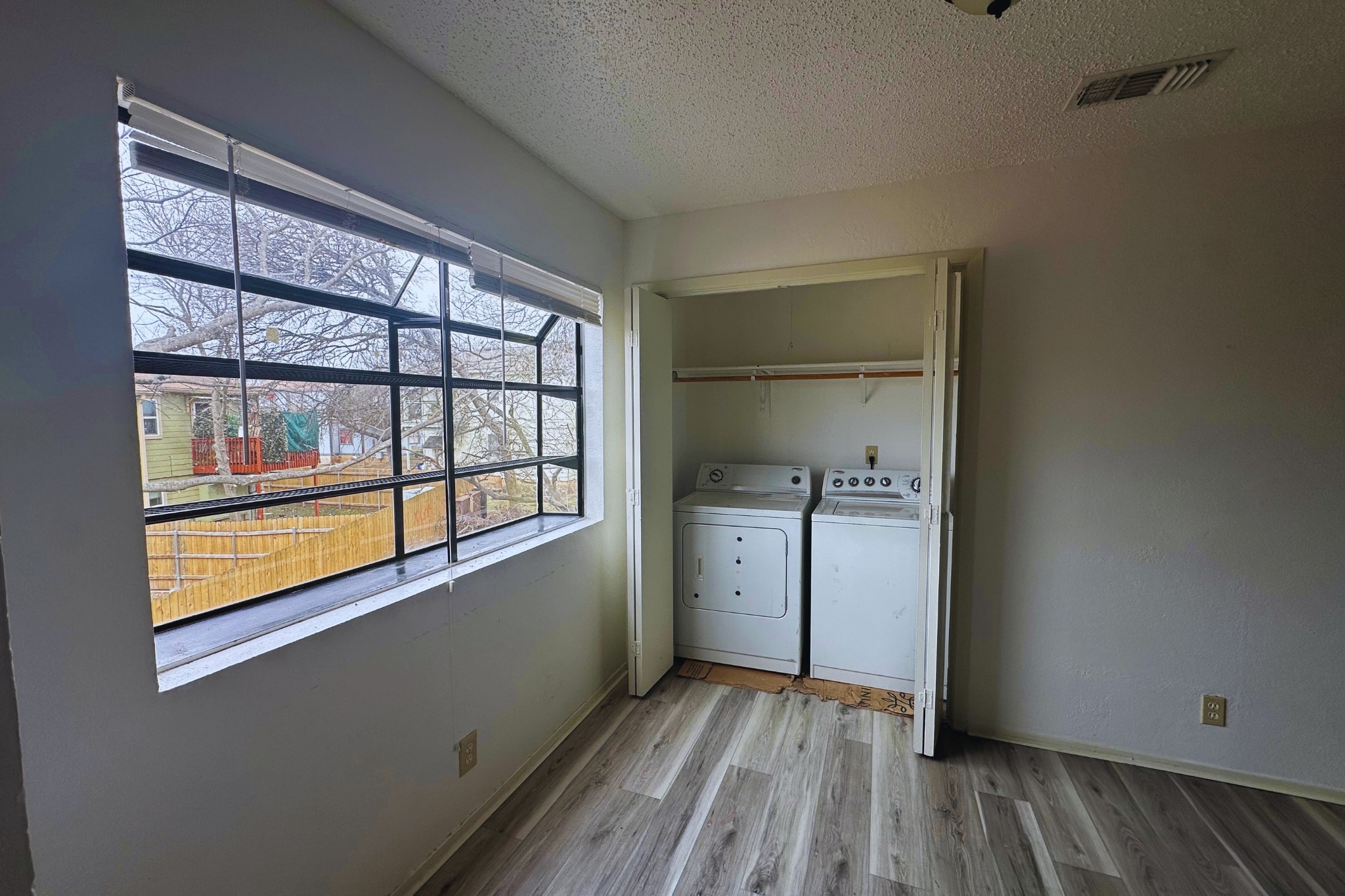 2202 Tabor Court, Unit C Austin, TX 78748 - Photo 6 of 14 Laundry area with a textured ceiling, light wood finished floors, and independent washer and dryer