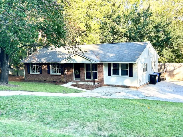 a front view of a house with a garden and porch