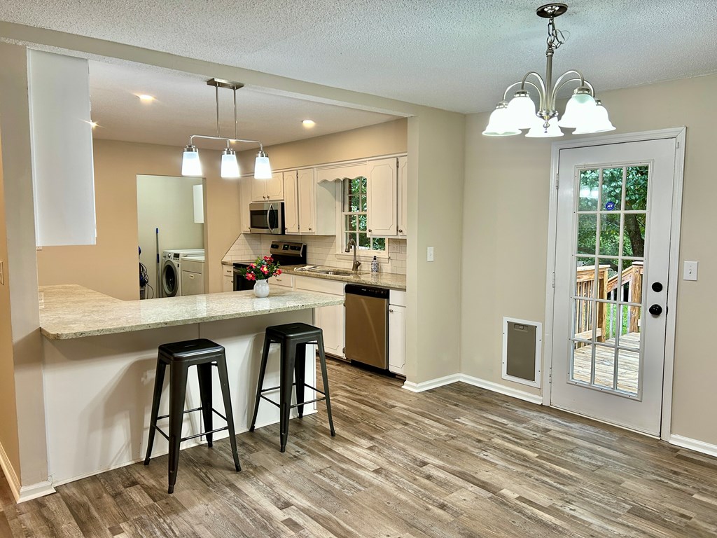 5636 Webb Avenue Columbus, GA 31909 - Photo 16 of 52 a kitchen with stainless steel appliances a dining table chairs and chandelier