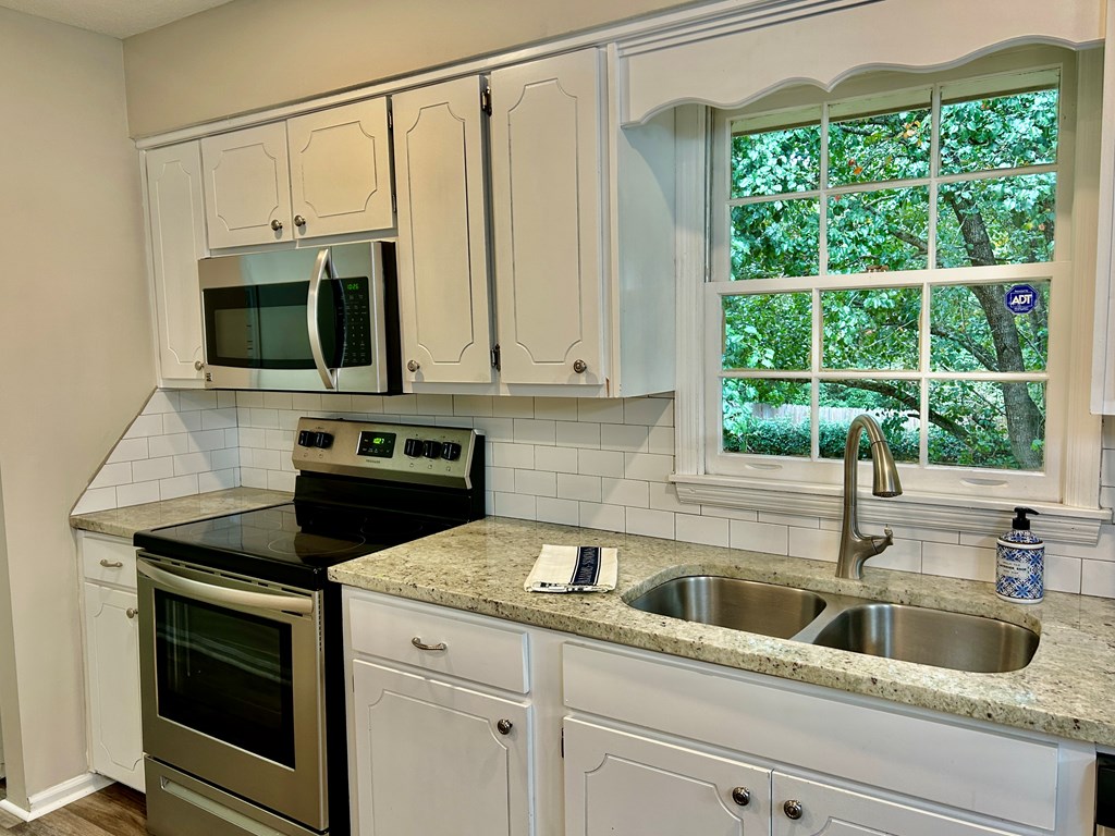 5636 Webb Avenue Columbus, GA 31909 - Photo 20 of 52 a kitchen with stainless steel appliances white cabinets a window and a sink