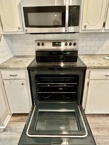 a kitchen with a stove and a microwave