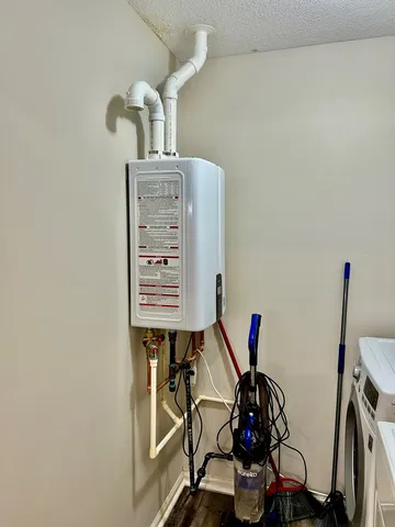 a view of a hallway with wooden floor and a bathroom