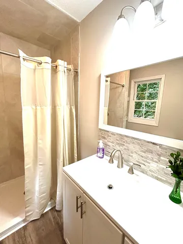 a bathroom with a double vanity sink and mirror