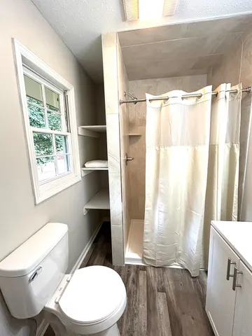 an empty room with a ceiling fan and a window