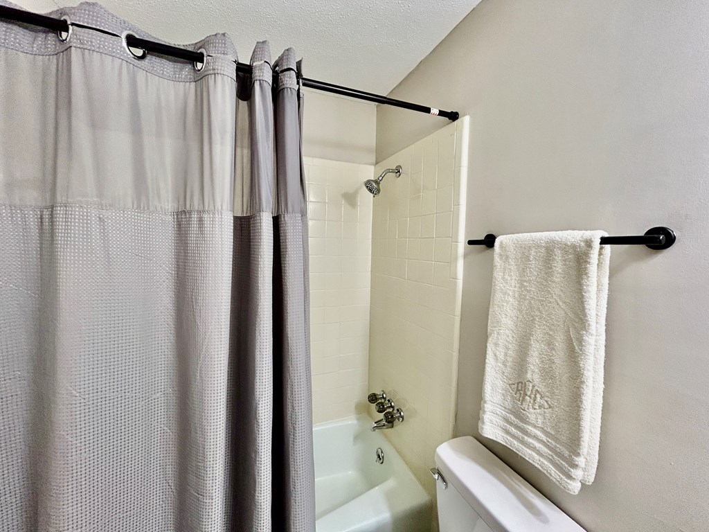 5636 Webb Avenue Columbus, GA 31909 - Photo 39 of 52 a bathroom with a shower curtain a bathtub and a shower