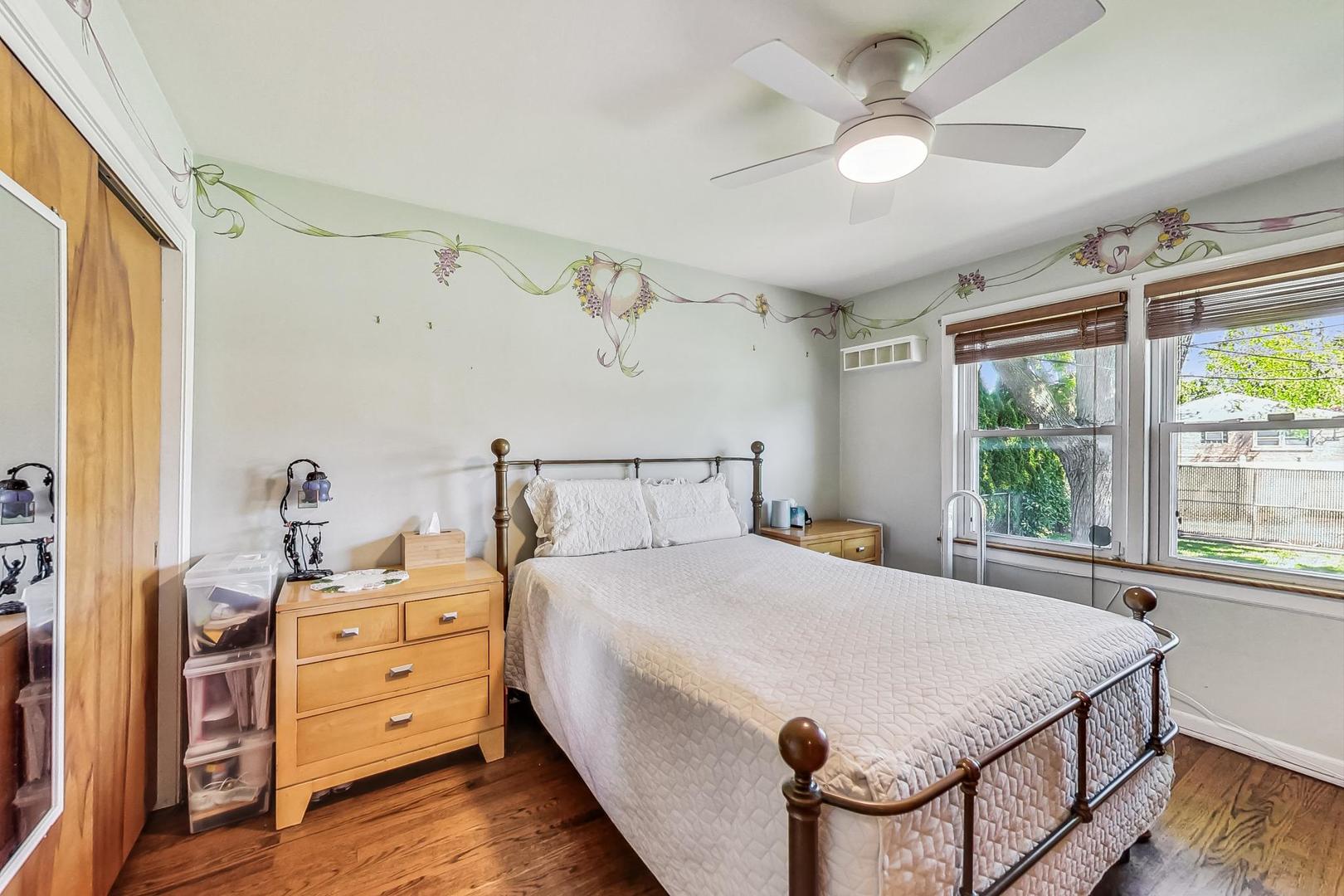 3312 Crain Street Skokie, IL 60076 - Photo 14 of 34 a bedroom with a bed and a chandelier