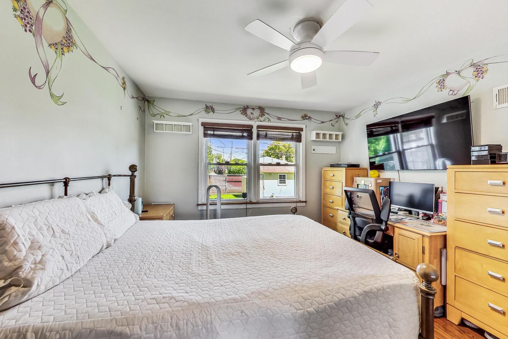 3312 Crain Street Skokie, IL 60076 - Photo 15 of 34 a bedroom with a bed and large windows