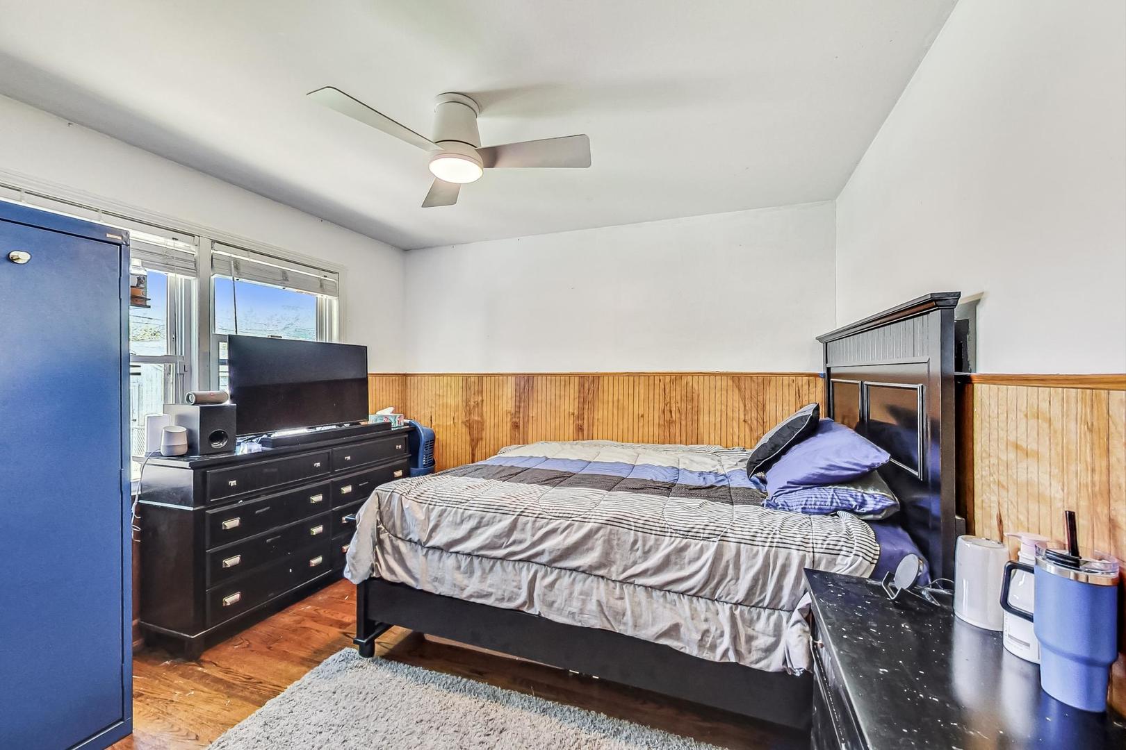 3312 Crain Street Skokie, IL 60076 - Photo 17 of 34 a bedroom with a bed and a flat screen tv