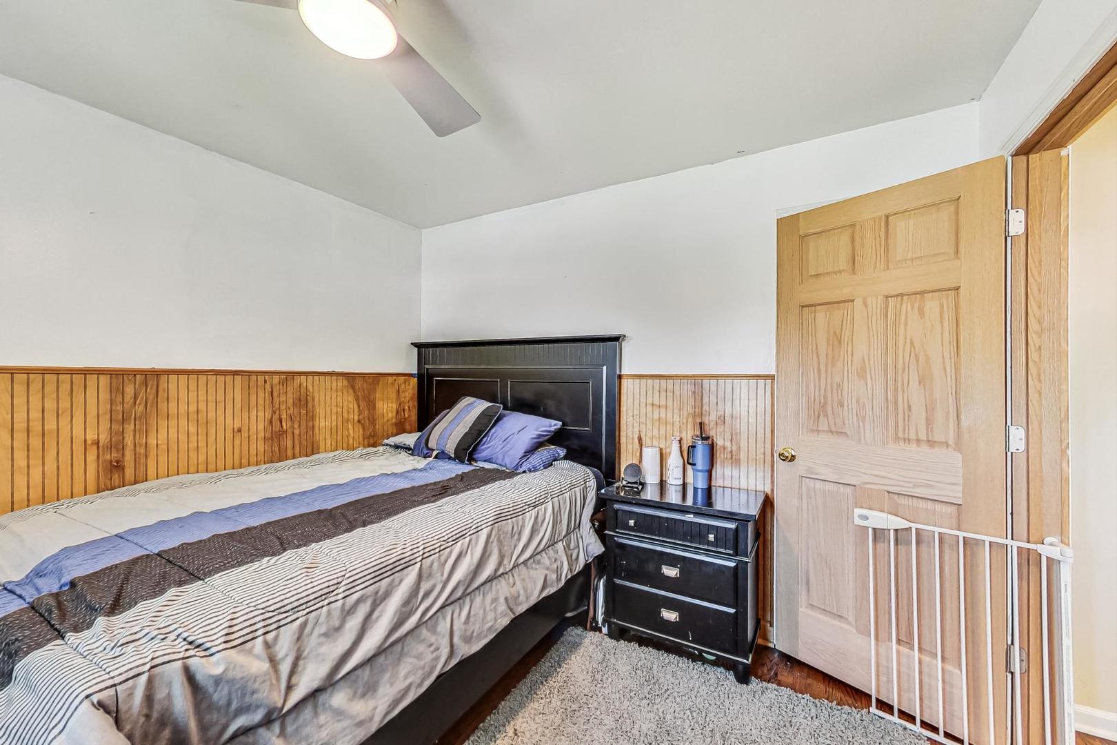 3312 Crain Street Skokie, IL 60076 - Photo 19 of 34 a bedroom with a bed and a night stand