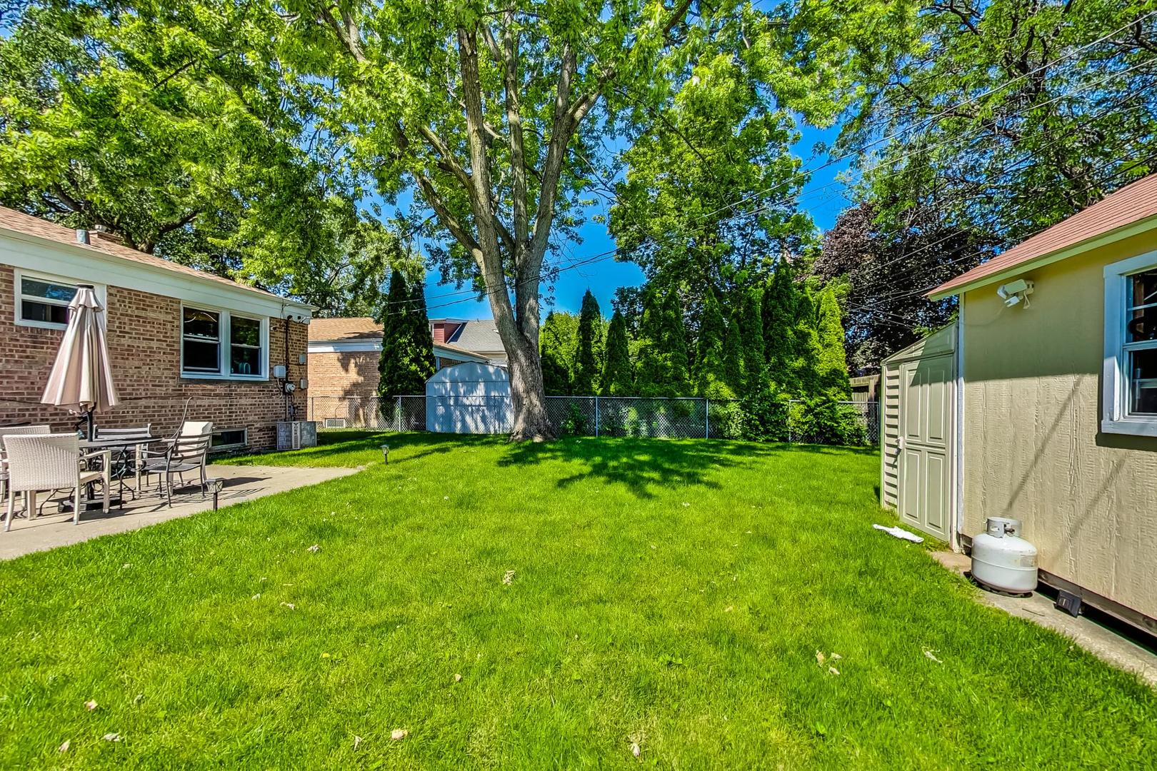 3312 Crain Street Skokie, IL 60076 - Photo 33 of 34 a view of a backyard with a garden and trees