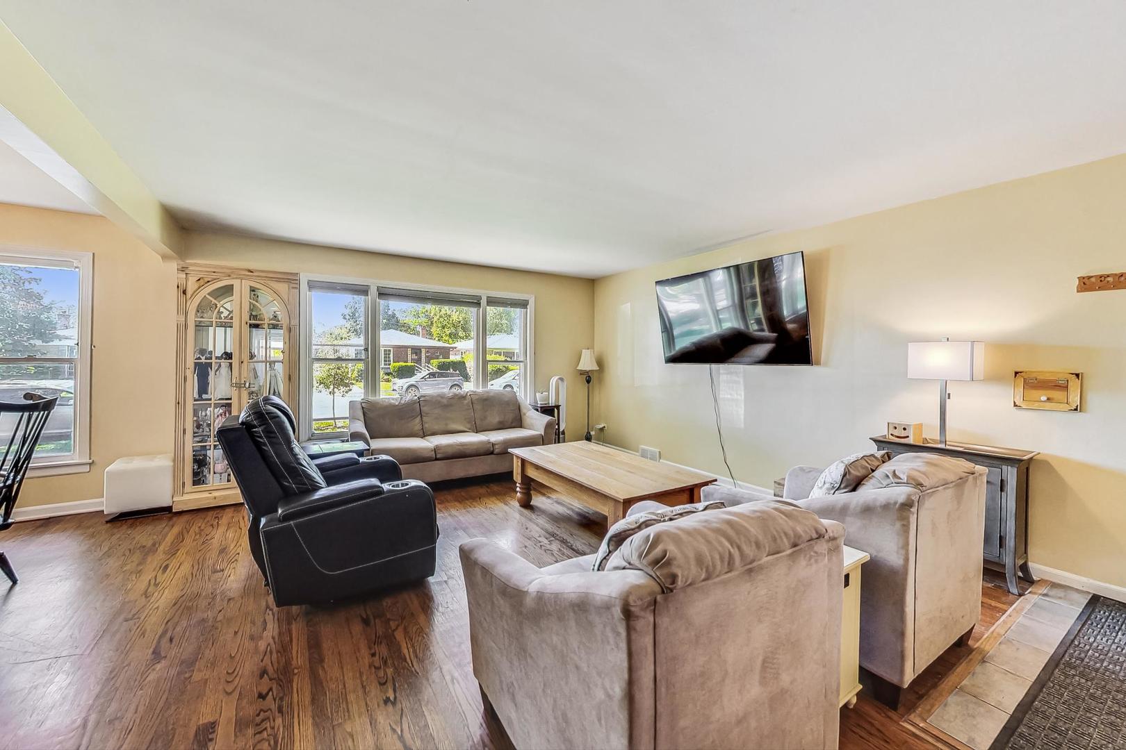 3312 Crain Street Skokie, IL 60076 - Photo 4 of 34 a living room with furniture and a flat screen tv