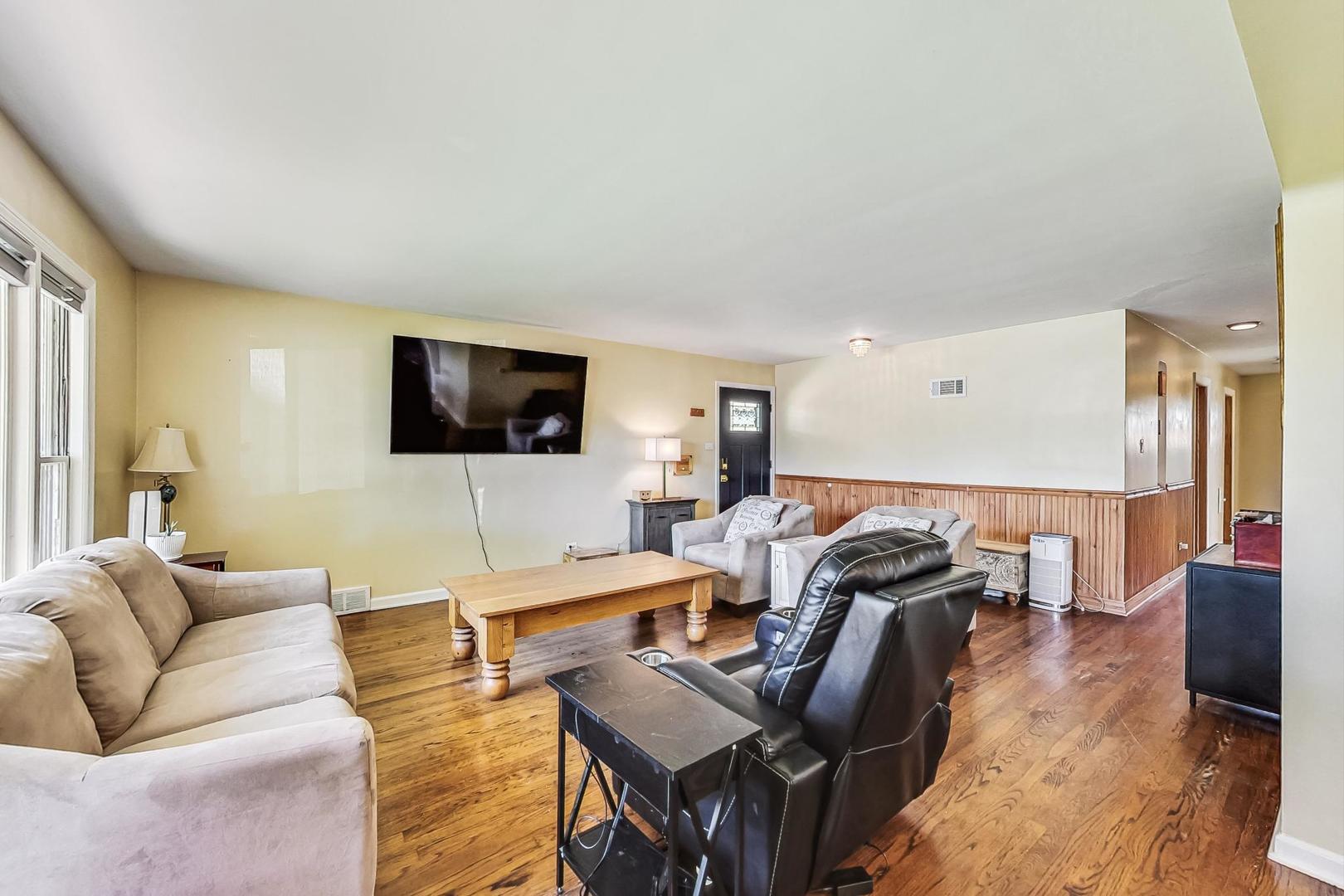 3312 Crain Street Skokie, IL 60076 - Photo 6 of 34 a living room with furniture and a flat screen tv