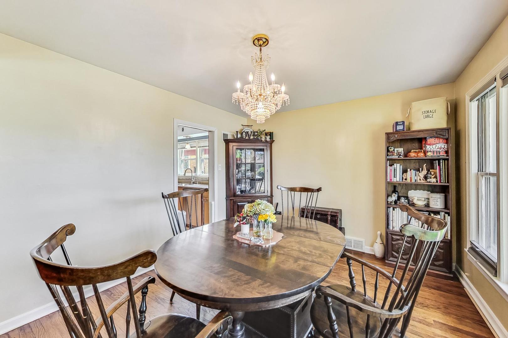 3312 Crain Street Skokie, IL 60076 - Photo 7 of 34 a view of a dining room with furniture and chandelier