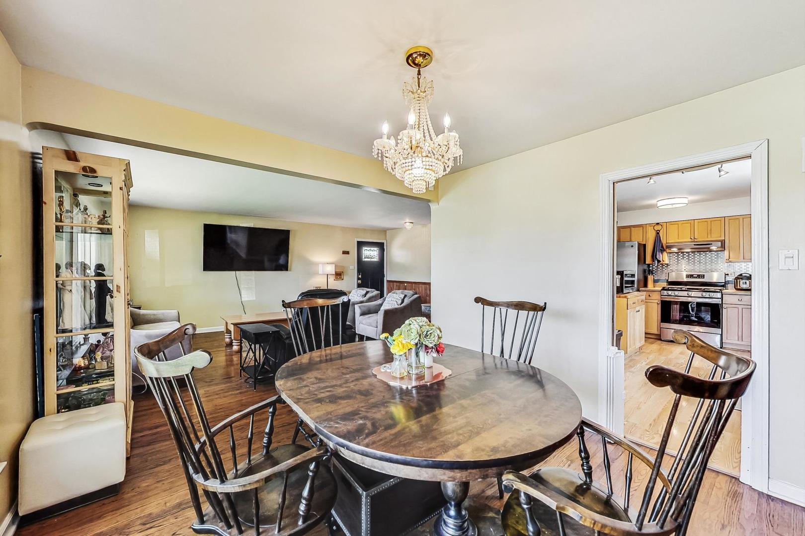 3312 Crain Street Skokie, IL 60076 - Photo 8 of 34 a view of a dining room with furniture and wooden floor