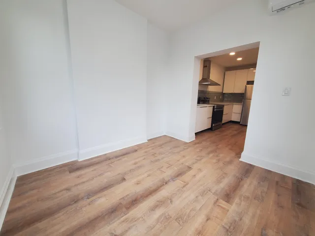 a view of a room with wooden floor and a sink