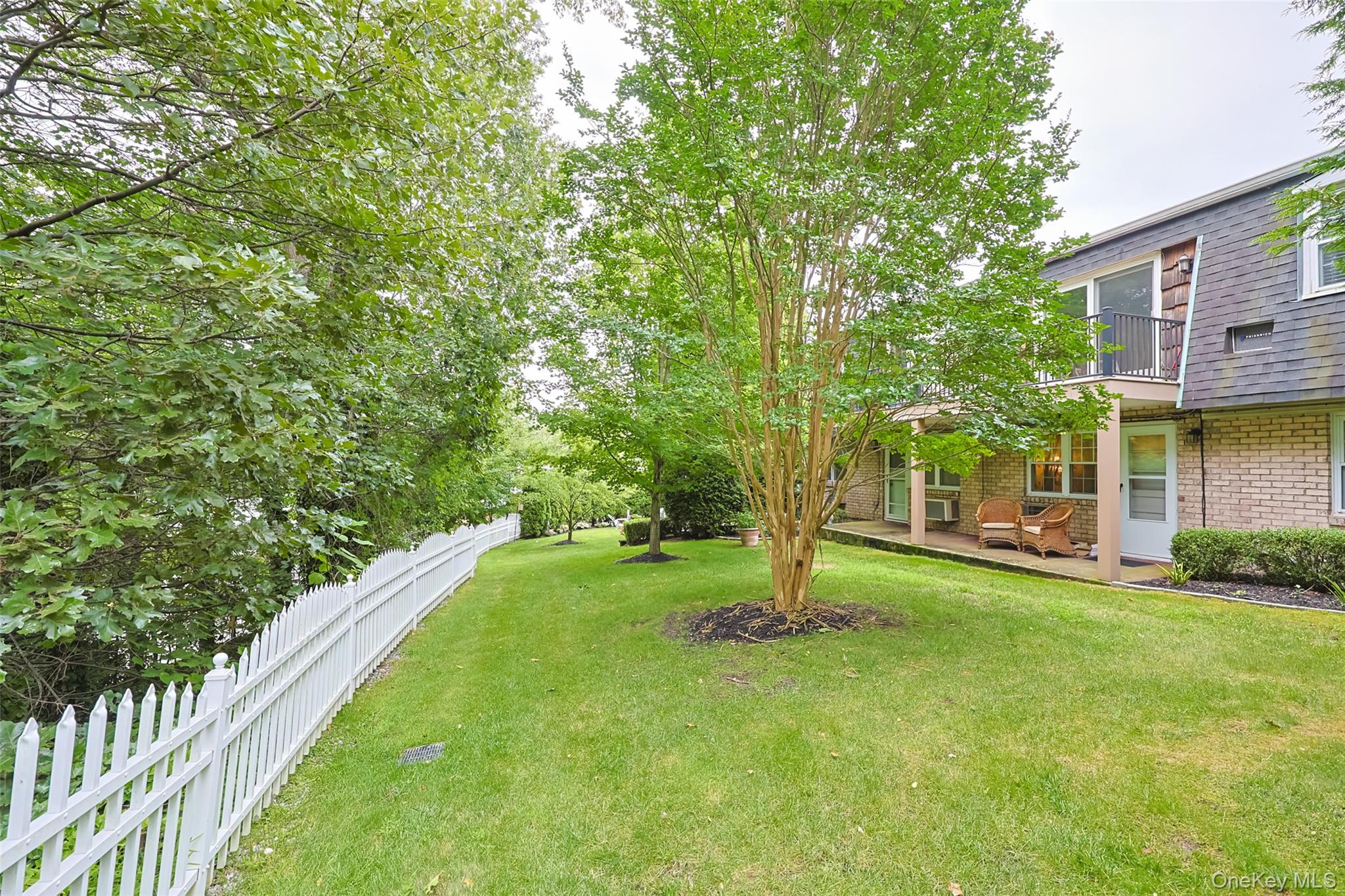 10 Harbour Lane, Unit 5A Oyster Bay, NY 11771 - Photo 18 of 25 View of yard featuring a balcony