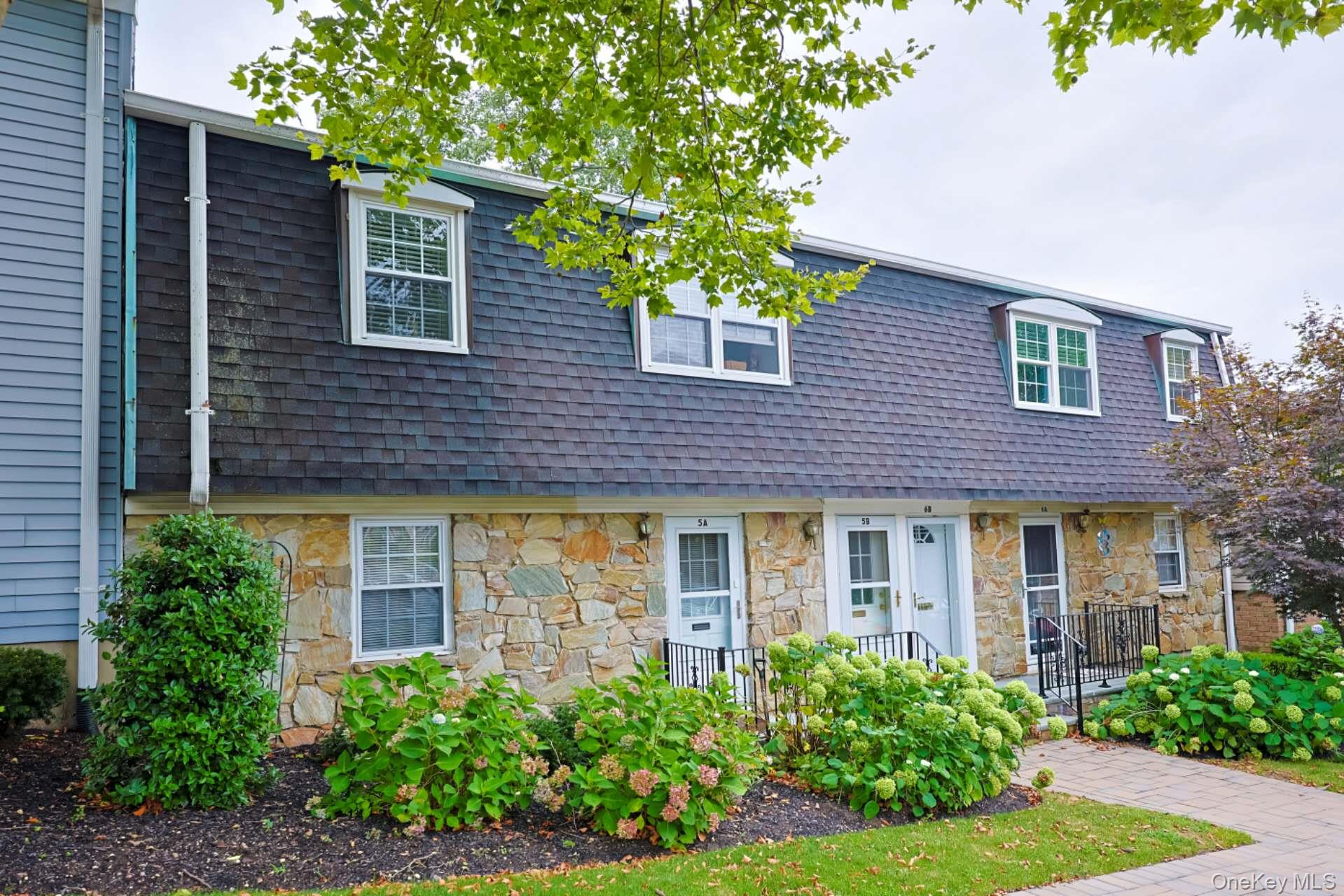 10 Harbour Lane, Unit 5A Oyster Bay, NY 11771 - Photo 19 of 25 Entry view – Additional perspective of the front entrance showcasing the private entryway, landscaped garden beds, and welcoming walkway to the home.
