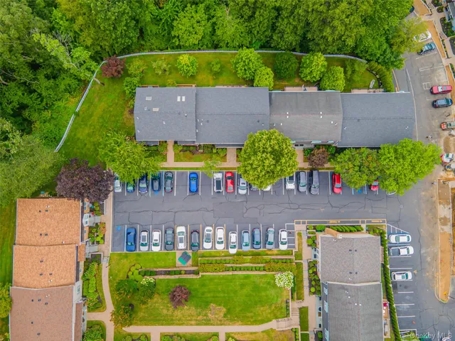 an aerial view of a house with a yard and potted plants