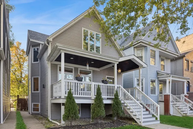a view of a house with a yard and deck