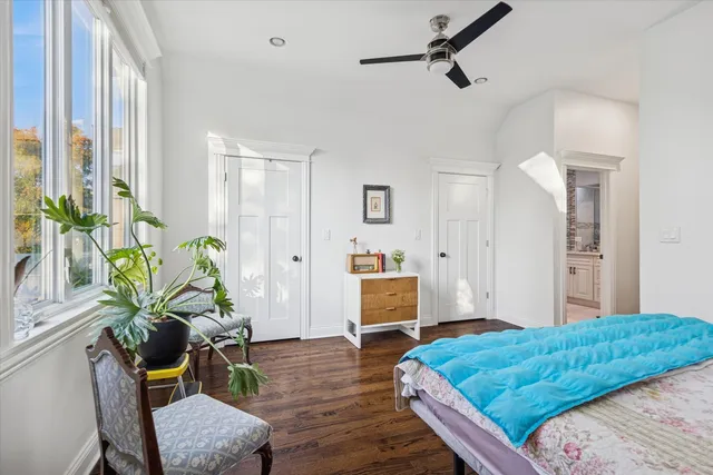 a bedroom with a bed window and table