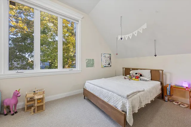 a bedroom with a bed a table and chair