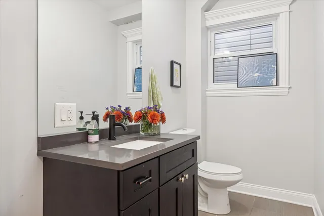 a bathroom with a sink vanity and a toilet