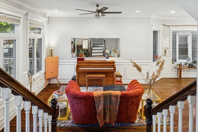 a living room with furniture a ceiling fan and a window