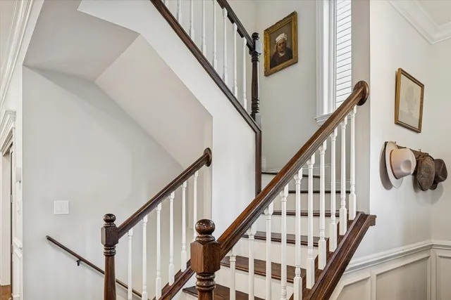 a view of staircase with wooden floor and white walls