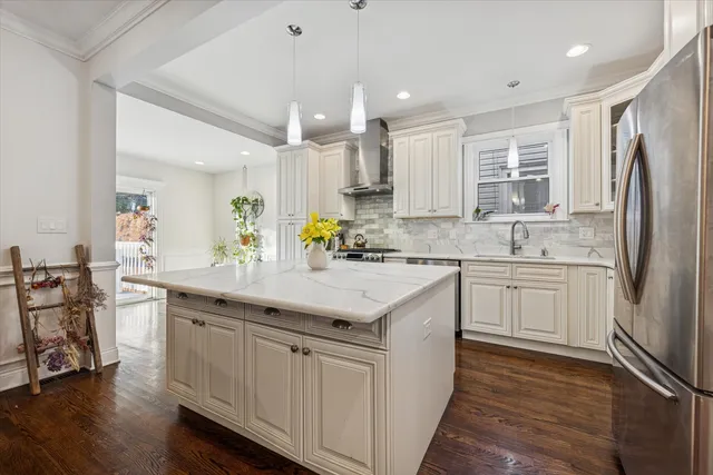 a kitchen with stainless steel appliances granite countertop a sink stove and refrigerator
