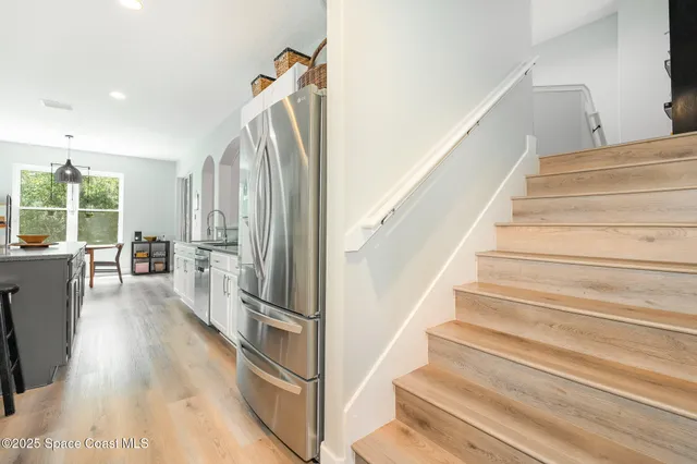 a view of entryway and hall with wooden floor