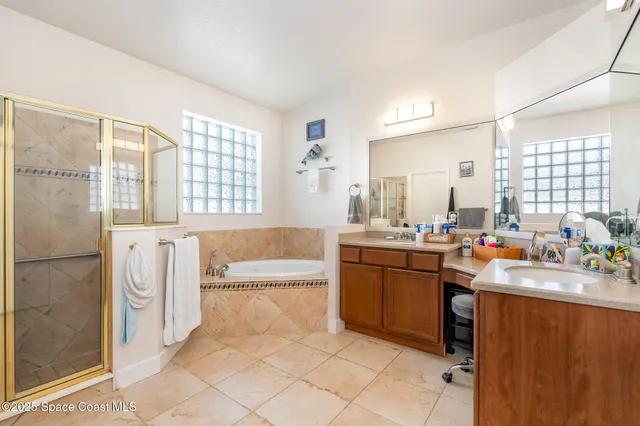 a large bathroom with a tub sink and mirror