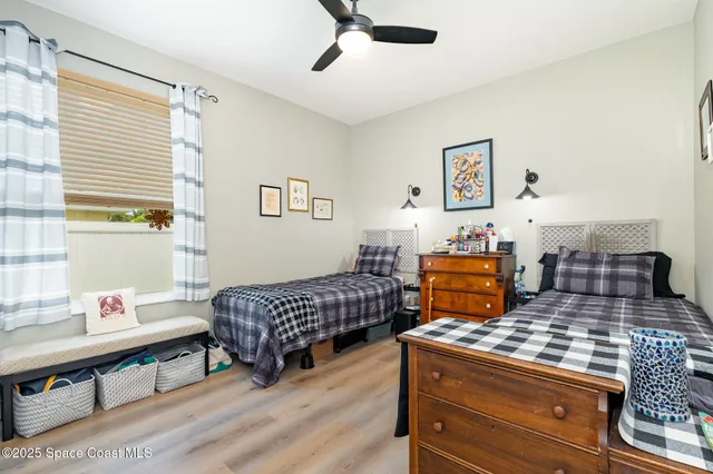 a living room with a bed and a dresser