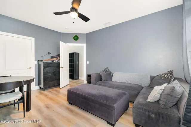 a living room with furniture a fireplace and a chandelier