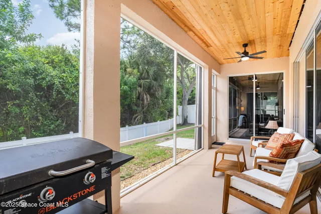 a balcony with furniture and a potted plant