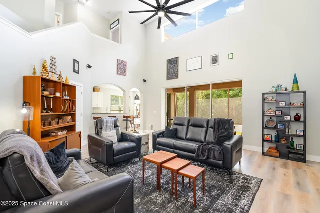 a living room with furniture a rug and a large window