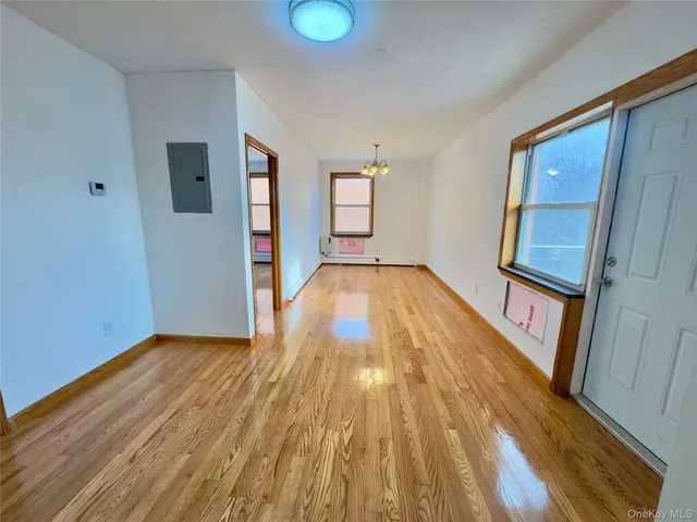 a view of a hallway view with wooden floor and staircase