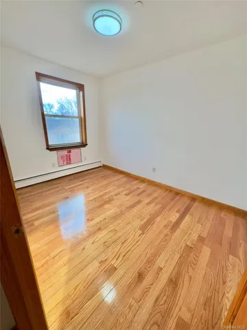 a view of a room with wooden floor and white walls