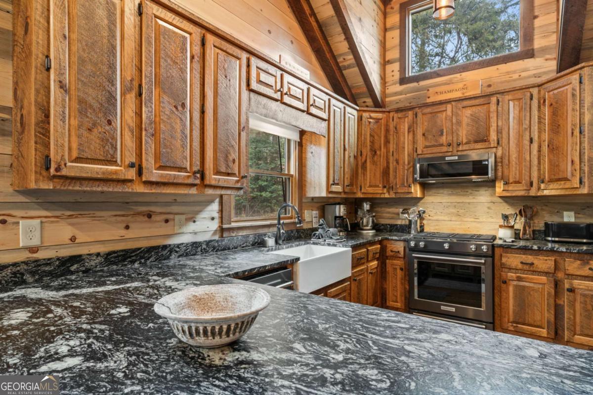 15 Bootleg Mountain Road, Unit 11 Morganton, GA 30560 - Photo 18 of 67 a kitchen with stainless steel appliances granite countertop a stove a sink and a granite counter tops