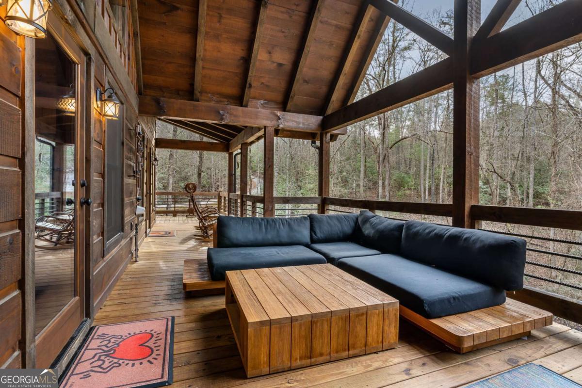 15 Bootleg Mountain Road, Unit 11 Morganton, GA 30560 - Photo 22 of 67 a living room with furniture and a floor to ceiling window