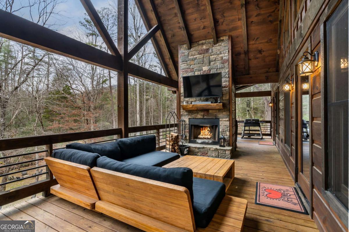 15 Bootleg Mountain Road, Unit 11 Morganton, GA 30560 - Photo 24 of 67 a living room with furniture a fireplace and a floor to ceiling window