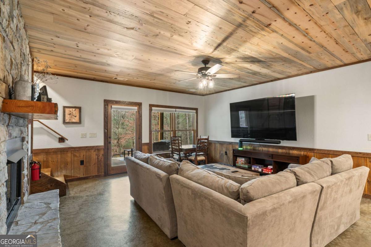 15 Bootleg Mountain Road, Unit 11 Morganton, GA 30560 - Photo 36 of 67 a living room with furniture and a flat screen tv