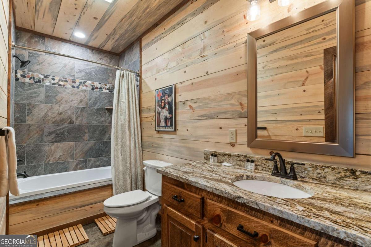 15 Bootleg Mountain Road, Unit 11 Morganton, GA 30560 - Photo 39 of 67 a bathroom with a granite countertop sink toilet and shower