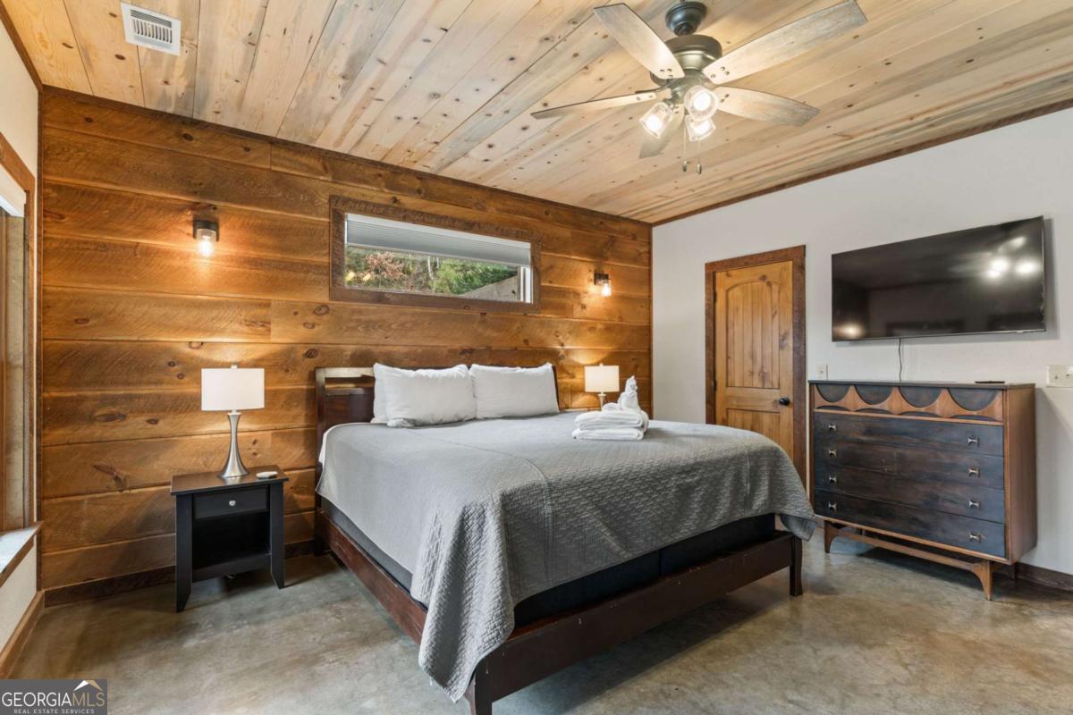 15 Bootleg Mountain Road, Unit 11 Morganton, GA 30560 - Photo 41 of 67 a bedroom with a bed and a flat screen tv