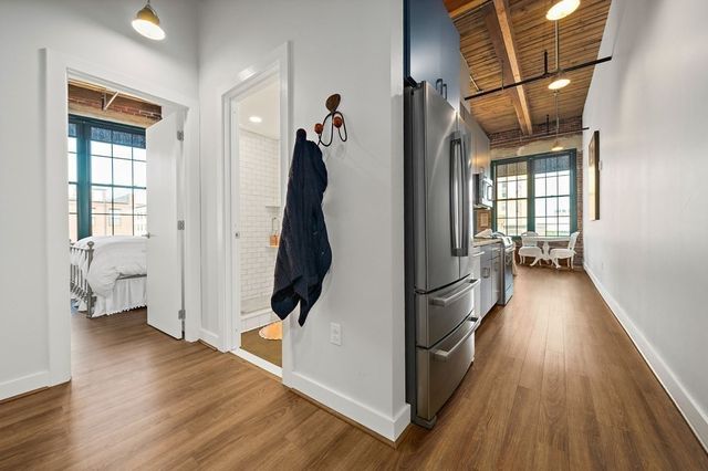 a bed sitting in a bedroom next to a window