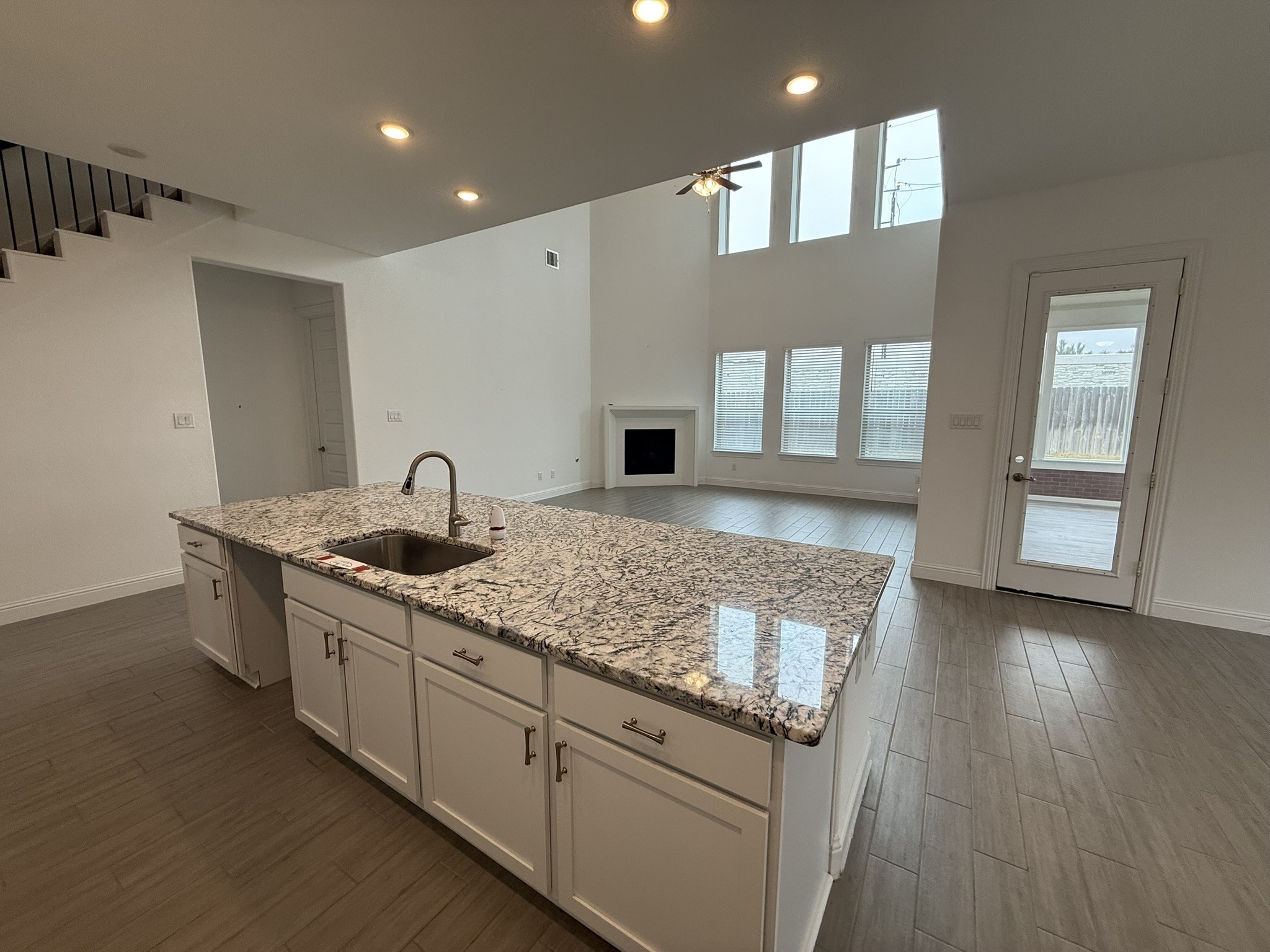 7802 Wayman Pass Fulshear, TX 77441 - Photo 14 of 50 a kitchen with stainless steel appliances granite countertop a sink stove and cabinets