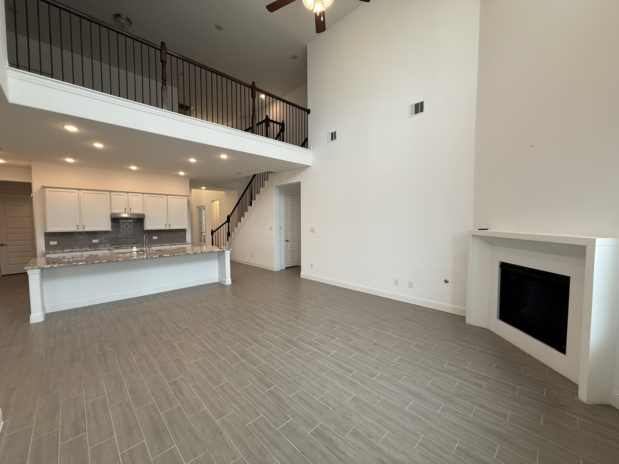7802 Wayman Pass Fulshear, TX 77441 - Photo 18 of 50 a view of an empty room with kitchen view