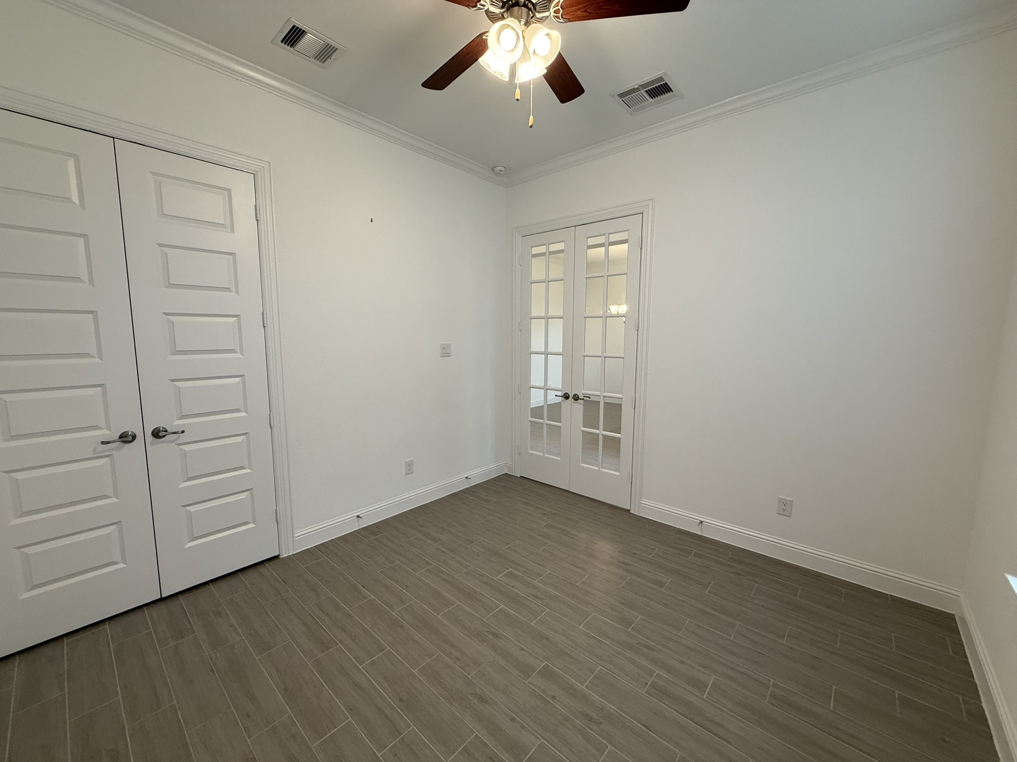 7802 Wayman Pass Fulshear, TX 77441 - Photo 21 of 50 an empty room with wooden floor closet and windows