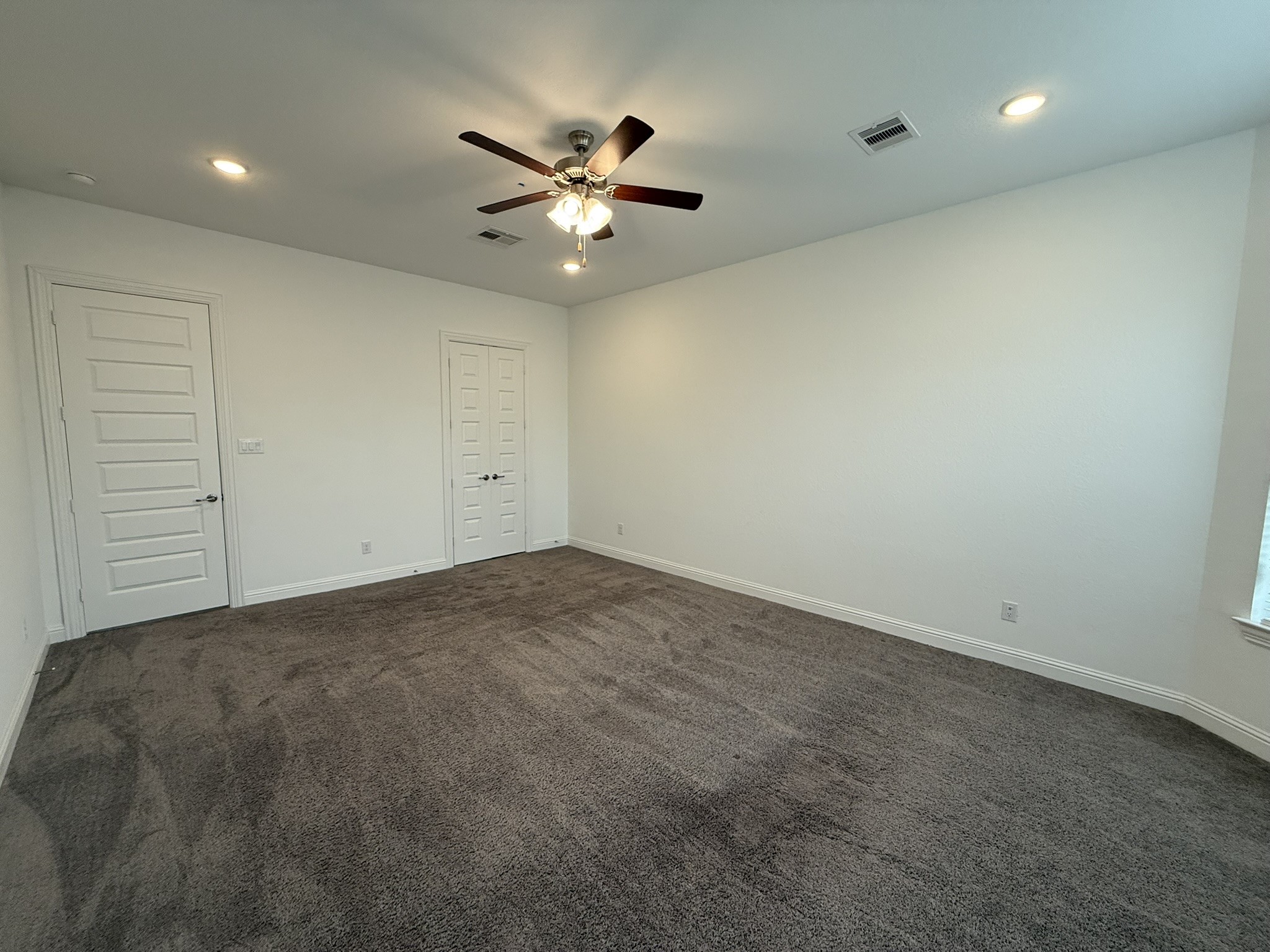 7802 Wayman Pass Fulshear, TX 77441 - Photo 26 of 50 an empty room with a fan and a window