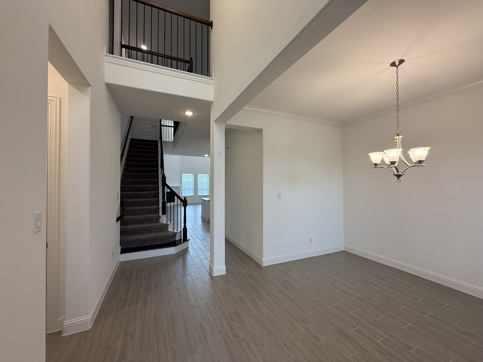 7802 Wayman Pass Fulshear, TX 77441 - Photo 4 of 50 a view of a hallway with wooden floor and staircase